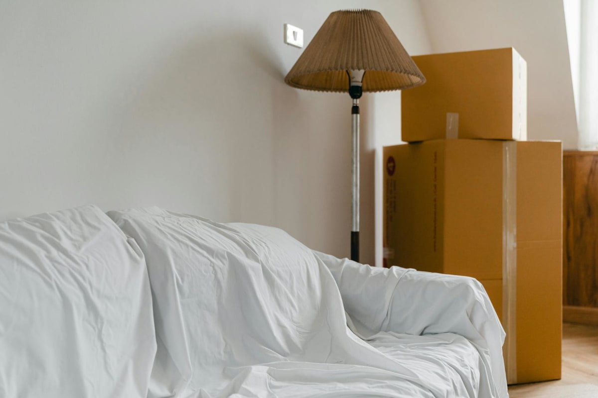 moving boxes stacked in empty apartment, cardboard boxes and packed items